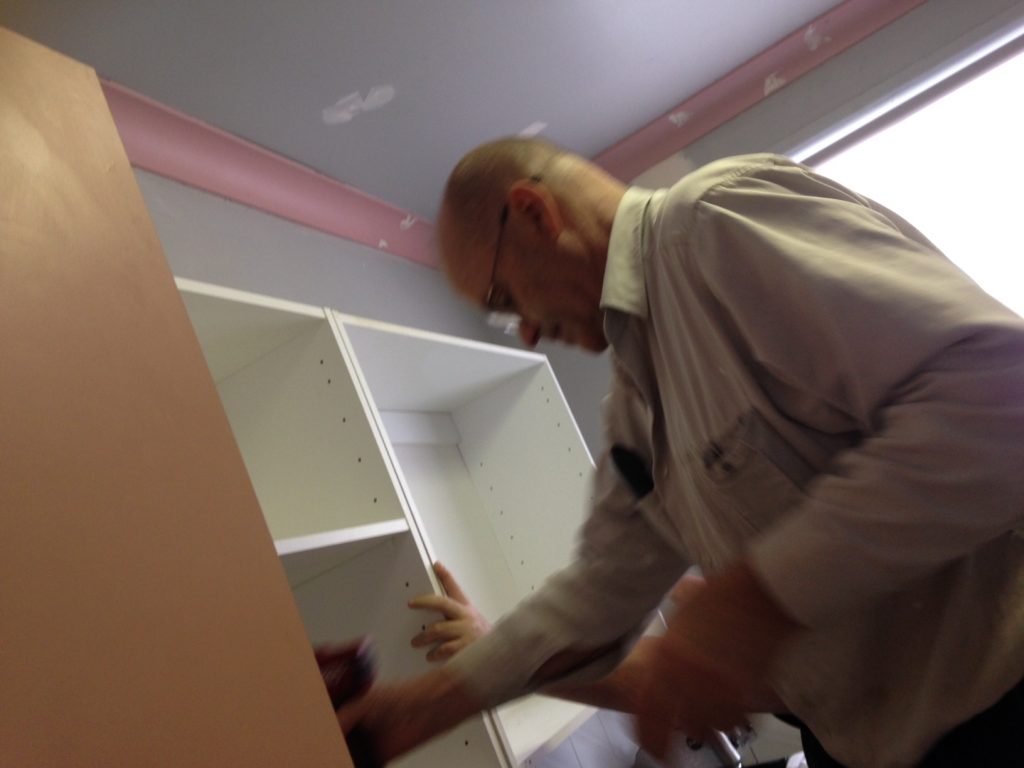 Dad helping to get the new (old) cupboards up